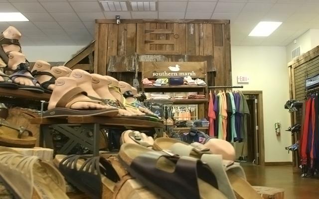 Interior photo of sporting goods on displays in River Outfitters